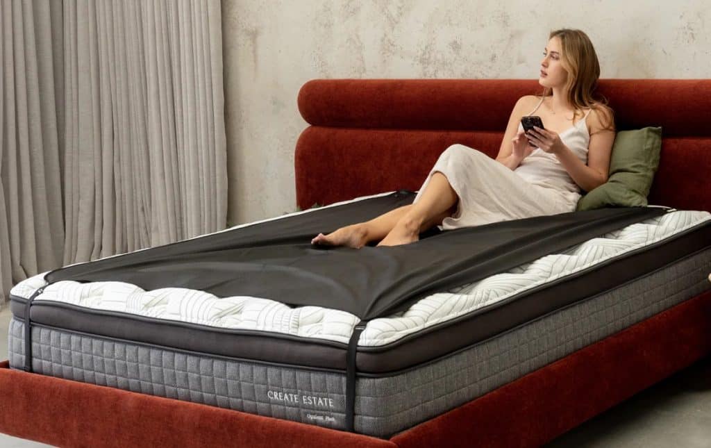 Down to Ground grounding mattress cover with young lady relaxing on it